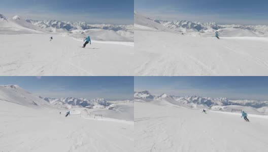 两个高山滑雪者在山坡上快速滑行高清在线视频素材下载