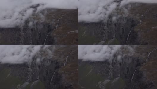 4K鸟瞰图的巨人与雾，瀑布，树木和山脉高清在线视频素材下载