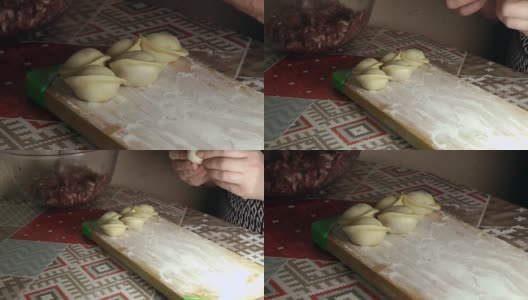 一个女人正在用里面的肉塑造面团来包饺子高清在线视频素材下载