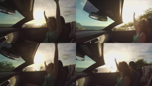 慢镜头:快乐的年轻女子高举双手坐在敞篷车里高清在线视频素材下载
