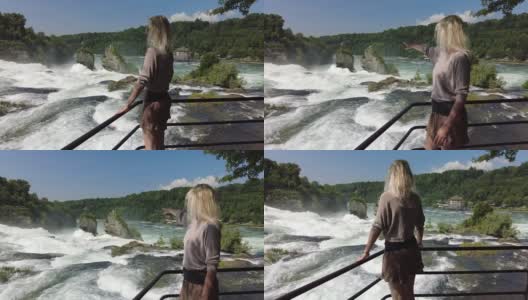 女人在莱茵瀑布瀑布高清在线视频素材下载
