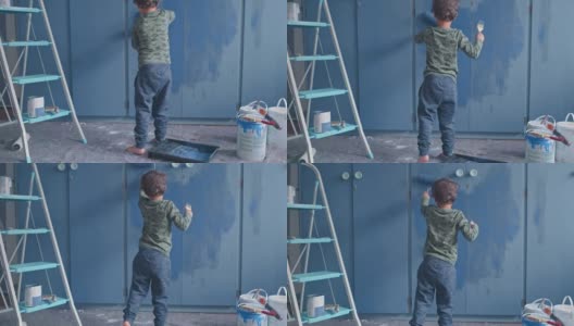一个可爱的小男孩在家里粉刷房间的4k视频片段高清在线视频素材下载