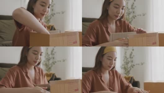 亚洲女人的主人包装纸板箱得到邮包。高清在线视频素材下载
