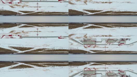 一架无人机飞过西伯利亚白雪皑皑的针叶林地带的一处工业设施。北方国家的工业在零度以下。视觉效果反映了两个世界高清在线视频素材下载