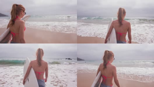 冲浪女孩在海滩上散步，面带微笑高清在线视频素材下载
