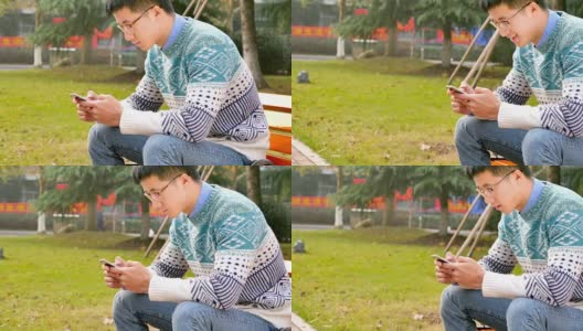 亚洲男子学生在公园拿着手机高清在线视频素材下载