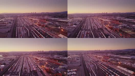 航空拍摄的多式铁路院子与市中心洛杉矶天际线高清在线视频素材下载