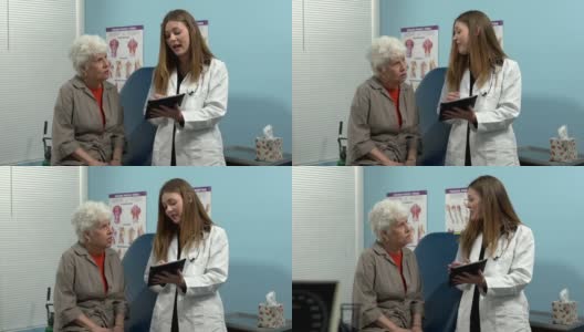 女医生用平板电脑与老年病人交谈高清在线视频素材下载