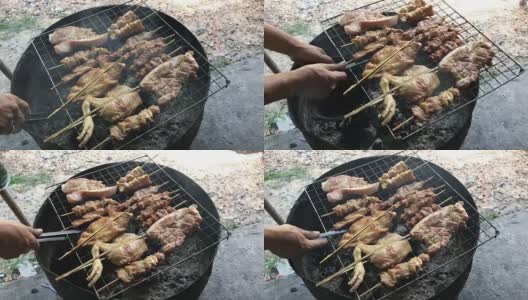 泰式街头小吃:炭火烤鸡，猪肉放在炉上半切油罐用烟熏。泰国风格的食物。泰式烧烤或“Moo Ping”在泰国字。4K视频高清在线视频素材下载