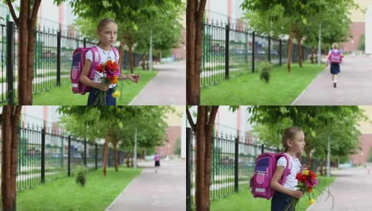 女生背着书包，捧着花束说声再见就走了。女孩站在学校附近，拿着一束花和背包。长途跋涉无重点的背景。夏日户外手持式拍摄。高清在线视频素材下载
