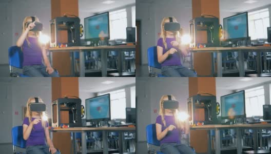 8-9岁女孩使用虚拟现实眼镜在学校课堂上探索3D虚拟现实。高清在线视频素材下载