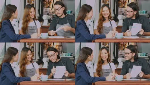 年轻的亚洲男人和女人，小企业在咖啡店咖啡店向亚洲商业女人解释财务和商业战略规划高清在线视频素材下载