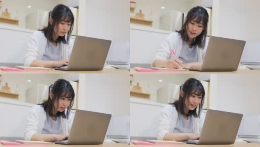 年轻女子在家工作，在笔记本电脑上输入信息高清在线视频素材下载