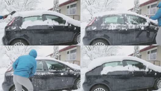 一个成年男子正在清除车上的积雪高清在线视频素材下载
