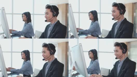亚洲人戴着耳机与客户在办公室进行电话支持高清在线视频素材下载