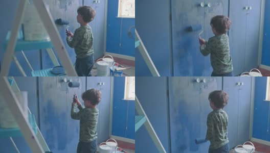 一个可爱的小男孩在家里粉刷房间的4k视频片段高清在线视频素材下载