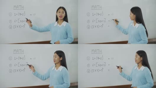 在教室里教学生的亚洲女教师。高清在线视频素材下载