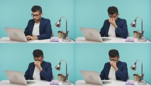 疲惫的商人用手指揉着眼睛戴着眼镜在办公室里用笔记本电脑工作，工作过度高清在线视频素材下载