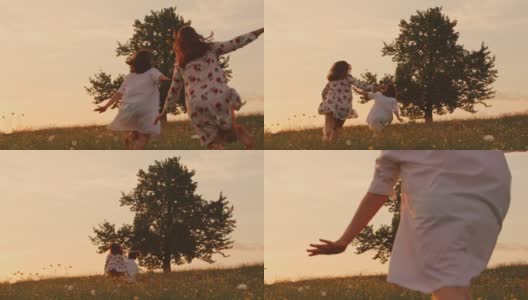 穿着裙子的女孩们在田园诗般的夏日草地上朝着树奔跑，实时播放高清在线视频素材下载