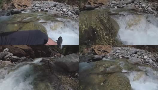 旅行者用动作摄影机探索一条山间河流。高清在线视频素材下载