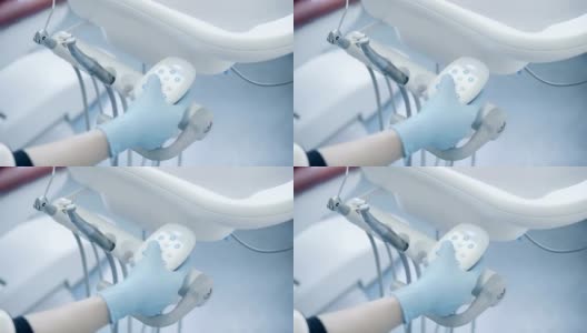 特写医生的手按下牙医椅上的按钮，切换模式。牙医手术高清在线视频素材下载