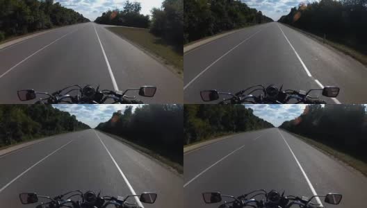 摩托车在森林之间的高速公路上行驶高清在线视频素材下载