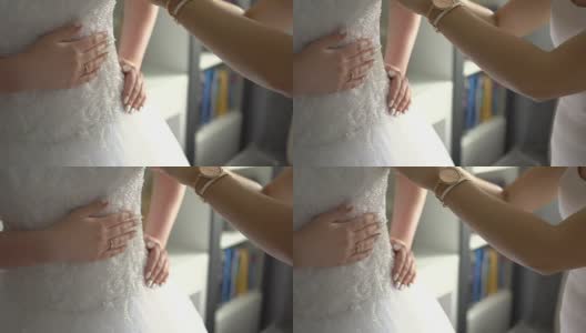 伴娘帮助新娘穿婚纱高清在线视频素材下载