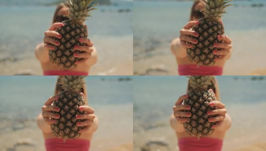 夏天，年轻女子捧着菠萝站在沙滩上高清在线视频素材下载