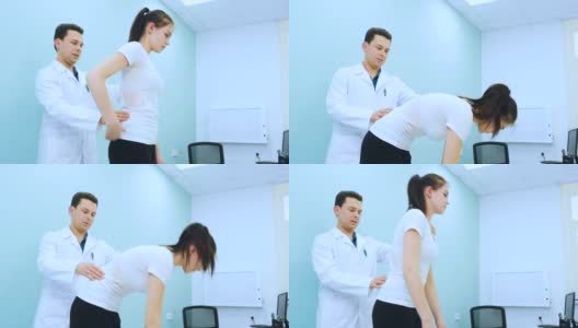 一个年轻的医生在康复室检查女孩的背部高清在线视频素材下载