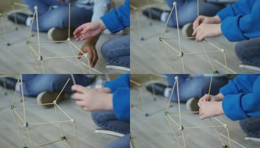 用木棍做房子模型的女孩的手高清在线视频素材下载