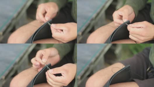 裁缝用自己的双手缝制一个皮包高清在线视频素材下载