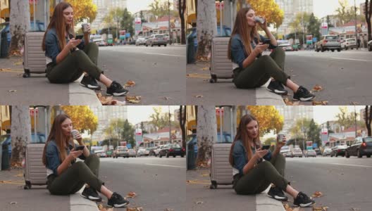 年轻漂亮的女人坐在人行道上用手机找出租车高清在线视频素材下载