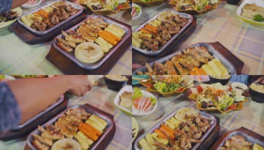 特写组的日本食物，鸡排，三文鱼片，沙拉，天妇罗虾在桌子上。高清在线视频素材下载
