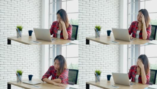 经济衰退压力女性使用笔记本电脑在家办公头痛，疲惫的失败业务挫折。压力大的亚洲女性焦虑过度工作，痛苦与生活危机累压力大的失业高清在线视频素材下载