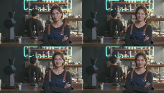 4K亚洲女咖啡厅老板的肖像，双手交叉站在吧台前高清在线视频素材下载