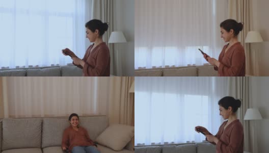 印度女性使用智能家居手机应用遮阳下窗高清在线视频素材下载