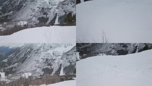 缓慢的运动。无人驾驶飞机射击。山顶的雪景与山坡上树木的平滑过渡高清在线视频素材下载