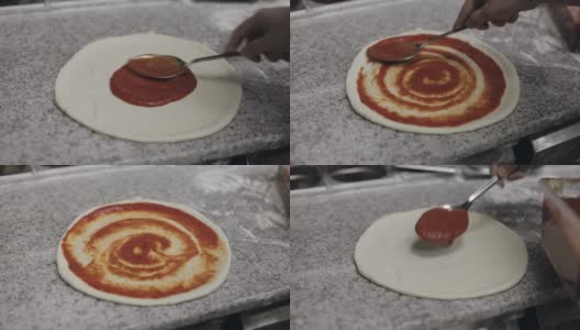 厨师做披萨。用番茄酱浸泡面团高清在线视频素材下载