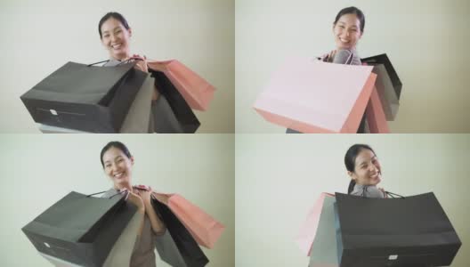 年轻快乐的亚洲女孩拿着很多购物袋高清在线视频素材下载