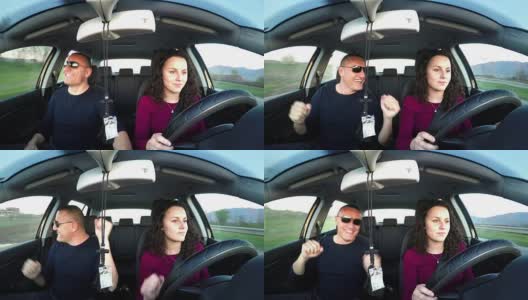 有趣的父亲跳舞而女儿在学开车高清在线视频素材下载