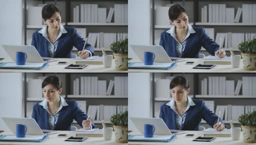 年轻女子在办公桌前工作高清在线视频素材下载