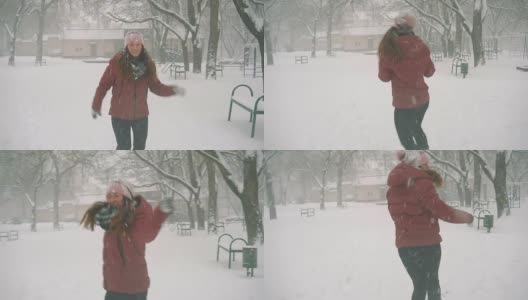 年轻女子在户外享受冬日。雪的冬天的梦想。慢动作高清在线视频素材下载