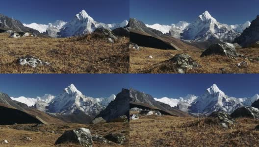 高耸的多岩石的雪山映衬着晴朗的天空。平衡稳定。尼泊尔萨加玛塔国家公园的Ama Dablam山，4K超高清高清在线视频素材下载
