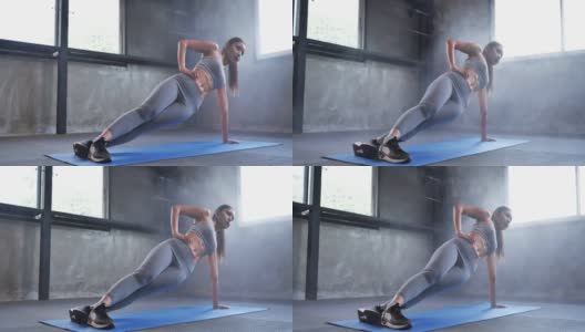亚洲年轻运动女性在健身房做腹肌锻炼，做侧平板支撑锻炼。高清在线视频素材下载