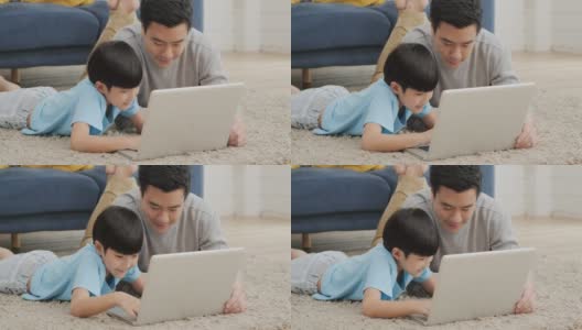 父子在家里一起使用电脑，心情愉快。家庭、科技和生活理念。高清在线视频素材下载