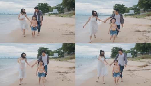 亚洲家庭与孩子们在海滩玩快乐假期的概念高清在线视频素材下载