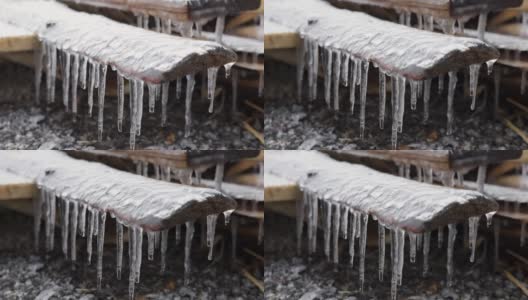 冰柱悬挂在木板上和水滴上。第一次霜冻。气候变化的概念。春天的时间高清在线视频素材下载