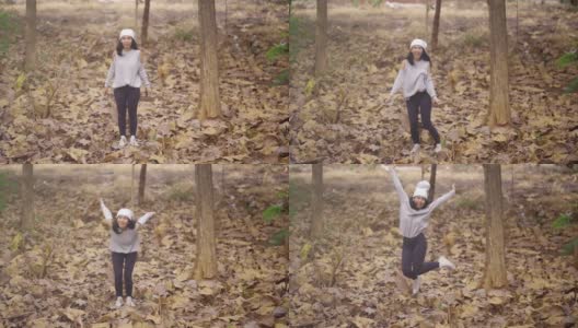 快乐的女人独自在秋天的公园里跳跃高清在线视频素材下载