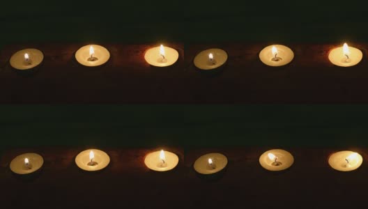 茶光蜡烛在黑暗中排成直线。浪漫的气氛和爱的心情。浅景深。高清在线视频素材下载
