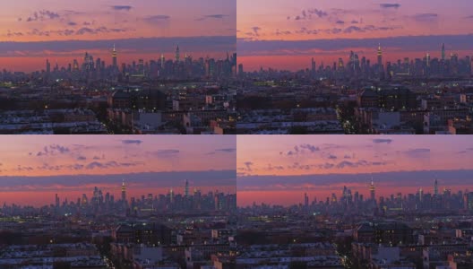 曼哈顿天际线在布鲁克林布什威克住宅区的夜晚被照亮的远景，在日落中。无人机视频与平移轨道摄像机运动。高清在线视频素材下载